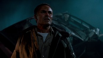 Movie still from “A Nightmare on Elm Street 3: Dream Warriors” (1987), directed by Chuck Russell – An older man standing in front of an airplane in the dark; Close Up shot, Low angle