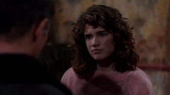 Movie still from “A Nightmare on Elm Street 3: Dream Warriors” (1987), directed by Chuck Russell – A woman with curly brown hair is looking at a man; Close Up shot, Over the shoulder angle