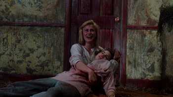 Movie still from “A Nightmare on Elm Street 3: Dream Warriors” (1987), directed by Chuck Russell – A woman and a child are sitting on the floor; Medium shot, Low angle
