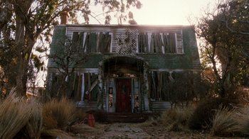 Movie still from “A Nightmare on Elm Street 4: The Dream Master” (1988), directed by Renny Harlin – An old house with a red door and a tree in front of it; Wide shot, Low angle