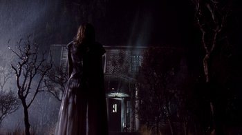 Movie still from “A Nightmare on Elm Street 4: The Dream Master” (1988), directed by Renny Harlin – A woman standing in front of a building at night; Wide shot, Low angle