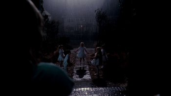 Movie still from “A Nightmare on Elm Street 4: The Dream Master” (1988), directed by Renny Harlin – A group of children are playing in the rain; Wide shot, High angle