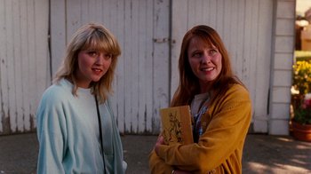 Movie still from “A Nightmare on Elm Street 4: The Dream Master” (1988), directed by Renny Harlin – Two women standing next to each other in front of a building; Medium shot, Low angle