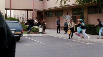 Movie still from “A Nightmare on Elm Street 4: The Dream Master” (1988), directed by Renny Harlin – A group of skateboarders and skateboarders on the sidewalk; Wide shot, High angle