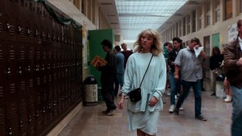 A woman walking down a hallway in a building