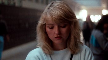 Movie still from “A Nightmare on Elm Street 4: The Dream Master” (1988), directed by Renny Harlin – A woman with blonde hair is looking down at her face; Close Up shot, Low angle