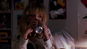 Movie still from “A Nightmare on Elm Street 4: The Dream Master” (1988), directed by Renny Harlin – A woman drinking a can of soda from a cup; Close Up shot, High angle