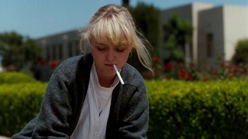 Movie still from “A Nightmare on Elm Street 4: The Dream Master” (1988), directed by Renny Harlin – A woman sitting outside with a cigarette in her mouth; Close Up shot, Low angle