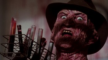 Movie still from “A Nightmare on Elm Street 4: The Dream Master” (1988), directed by Renny Harlin – The face of an evil looking creature; Close Up shot, Low angle
