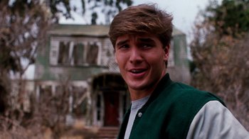 Movie still from “A Nightmare on Elm Street 4: The Dream Master” (1988), directed by Renny Harlin – A young man in front of an abandoned house; Close Up shot, Low angle