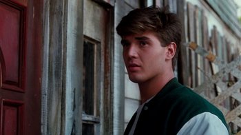 Movie still from “A Nightmare on Elm Street 4: The Dream Master” (1988), directed by Renny Harlin – A young man standing in front of an old building; Close Up shot, Low angle