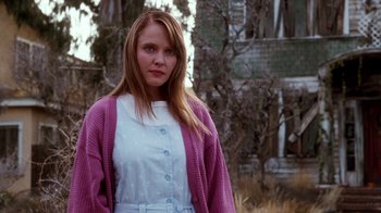Movie still from “A Nightmare on Elm Street 4: The Dream Master” (1988), directed by Renny Harlin – A woman in a white dress and a pink sweater; Medium shot, Low angle