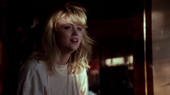 Movie still from “A Nightmare on Elm Street 4: The Dream Master” (1988), directed by Renny Harlin – A woman with blonde hair is standing in a dark room; Close Up shot, Low angle