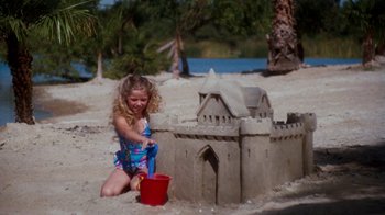 Movie still from “A Nightmare on Elm Street 4: The Dream Master” (1988), directed by Renny Harlin – A little girl playing in the sand on the beach; Wide shot, High angle
