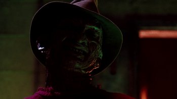 Movie still from “A Nightmare on Elm Street 4: The Dream Master” (1988), directed by Renny Harlin – The face of a man wearing a hat; Close Up shot, Low angle
