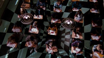 Movie still from “A Nightmare on Elm Street 4: The Dream Master” (1988), directed by Renny Harlin – A group of people sitting at a table with papers; Extreme Wide shot, Overhead angle