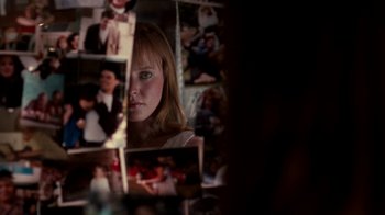 Movie still from “A Nightmare on Elm Street 4: The Dream Master” (1988), directed by Renny Harlin – A woman looking into a mirror in a room with pictures on the wall; Extreme Close Up shot, Over the shoulder angle