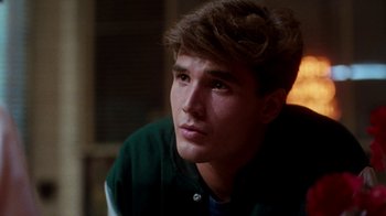 Movie still from “A Nightmare on Elm Street 4: The Dream Master” (1988), directed by Renny Harlin – A young man sitting in front of a window; Close Up shot, Low angle