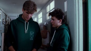 Movie still from “A Nightmare on Elm Street 4: The Dream Master” (1988), directed by Renny Harlin – Two young men in green sweatshirts standing next to each other; Medium shot, Over the shoulder angle