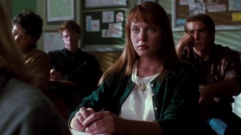 Movie still from “A Nightmare on Elm Street 4: The Dream Master” (1988), directed by Renny Harlin – A woman sitting at a table in front of other people; Medium shot, Over the shoulder angle