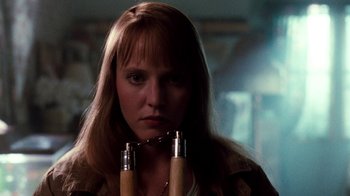 Movie still from “A Nightmare on Elm Street 4: The Dream Master” (1988), directed by Renny Harlin – A woman with a chain around her neck; Close Up shot, Low angle