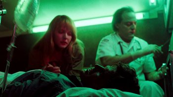 Movie still from “A Nightmare on Elm Street 4: The Dream Master” (1988), directed by Renny Harlin – A woman and a man sitting on a bed in a room; Medium shot, Low angle