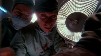 Movie still from “A Nightmare on Elm Street 4: The Dream Master” (1988), directed by Renny Harlin – A man in a surgical gown and a hat is in front of an electric fan; Close Up shot, Low angle