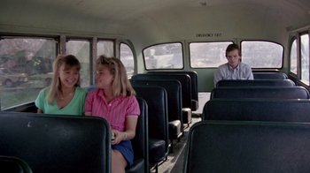 Movie still from “A Nightmare on Elm Street 2: Freddy's Revenge” (1985), directed by Jack Sholder – A group of people sitting in a bus; Wide shot, Over the shoulder angle