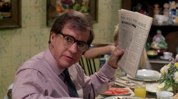 Movie still from “A Nightmare on Elm Street 2: Freddy's Revenge” (1985), directed by Jack Sholder – A man sitting at a dinner table holding a newspaper; Close Up shot, Over the shoulder angle