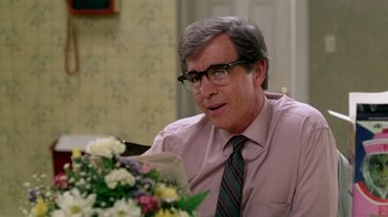 Movie still from “A Nightmare on Elm Street 2: Freddy's Revenge” (1985), directed by Jack Sholder – An older man sitting at a table with a bouquet of flowers in front of him; Close Up shot, Over the shoulder angle