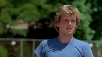 Movie still from “A Nightmare on Elm Street 2: Freddy's Revenge” (1985), directed by Jack Sholder – A man in a blue shirt is looking at the camera; Close Up shot, Low angle
