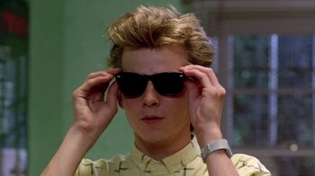 Movie still from “A Nightmare on Elm Street 2: Freddy's Revenge” (1985), directed by Jack Sholder – A young man wearing a pair of black sunglasses; Close Up shot, Low angle