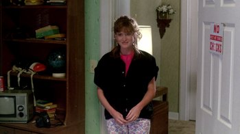 Movie still from “A Nightmare on Elm Street 2: Freddy's Revenge” (1985), directed by Jack Sholder – A woman standing in front of a green wall; Medium shot, Over the shoulder angle