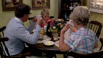 Movie still from “A Nightmare on Elm Street 2: Freddy's Revenge” (1985), directed by Jack Sholder – Three people sitting at a table drinking coffee; Medium shot, High angle