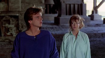 Movie still from “A Nightmare on Elm Street 2: Freddy's Revenge” (1985), directed by Jack Sholder – A man and a woman standing next to each other; Medium shot, Over the shoulder angle
