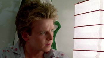 Movie still from “A Nightmare on Elm Street 2: Freddy's Revenge” (1985), directed by Jack Sholder – A person with long blonde hair; Close Up shot, Low angle