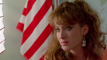 Movie still from “A Nightmare on Elm Street 2: Freddy's Revenge” (1985), directed by Jack Sholder – A person with a flag in the background; Close Up shot, Over the shoulder angle