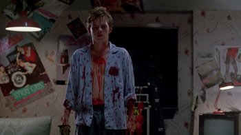 Movie still from “A Nightmare on Elm Street 2: Freddy's Revenge” (1985), directed by Jack Sholder – A man with blood all over his shirt; Medium shot, Low angle