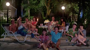 Movie still from “A Nightmare on Elm Street 2: Freddy's Revenge” (1985), directed by Jack Sholder – A group of people sitting on lawn chairs at night; Wide shot, High angle