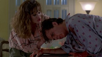 Movie still from “A Nightmare on Elm Street 2: Freddy's Revenge” (1985), directed by Jack Sholder – A man and a woman laying on a table; Medium shot, Low angle