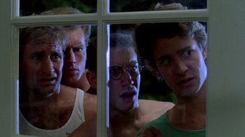 Movie still from “A Nightmare on Elm Street 2: Freddy's Revenge” (1985), directed by Jack Sholder – A group of people looking through a window; Close Up shot, Low angle