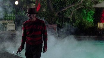 Movie still from “A Nightmare on Elm Street 2: Freddy's Revenge” (1985), directed by Jack Sholder – A man dressed as freddy krueger walking through smoke; Wide shot, Low angle