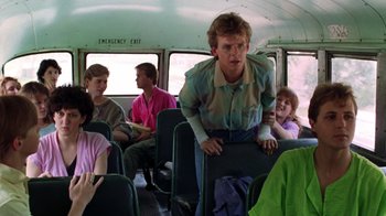 Movie still from “A Nightmare on Elm Street 2: Freddy's Revenge” (1985), directed by Jack Sholder – A group of people sitting on a bus; Medium shot, Over the shoulder angle