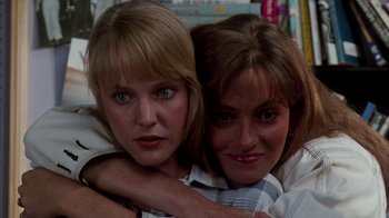 Movie still from “A Nightmare on Elm Street: The Dream Child” (1989), directed by Stephen Hopkins – Two women are hugging and smiling for the camera; Close Up shot, Low angle