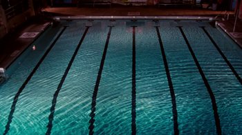 Movie still from “A Nightmare on Elm Street: The Dream Child” (1989), directed by Stephen Hopkins – An empty swimming pool at night with a lot of water; Extreme Wide shot, Overhead angle