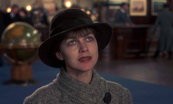 Movie still from “A Passage to India” (1984), directed by David Lean – A woman wearing a black hat and a sweater; Close Up shot, Over the shoulder angle