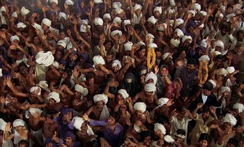 Movie still from “A Passage to India” (1984), directed by David Lean – A large group of people wearing white hats; Extreme Wide shot, High angle
