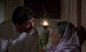 Movie still from “A Passage to India” (1984), directed by David Lean – An older woman and a younger man are talking; Medium shot, Over the shoulder angle