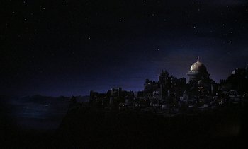 Movie still from “A Passage to India” (1984), directed by David Lean – A night view of a city lit up by the lights; Extreme Wide shot, Low angle