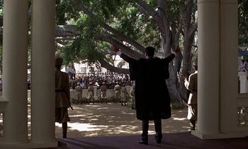 Movie still from “A Passage to India” (1984), directed by David Lean – A group of people standing in front of a tree; Extreme Wide shot, High angle